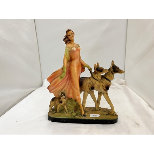 109 - AN EARLY 20TH CENTURY ART DECO STYLE CHALKWARE FIGURE OF A LADY AND TWO GERMAN SHEPHERDS MARKED RD 8... 