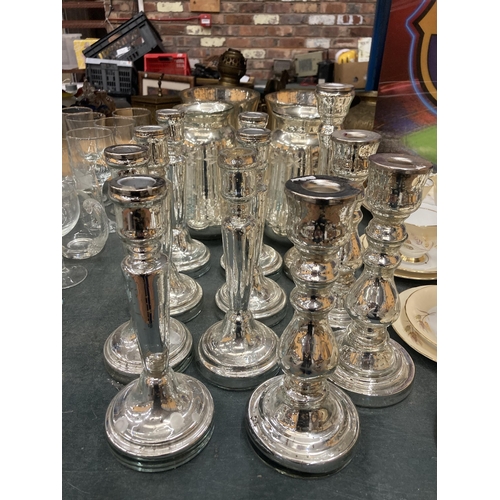 297 - A QUANTITY OF SILVER COLOURED CANDLESTICKS - 11 IN TOTAL PLUS FOUR SILVER COLOURED GLASS VASES