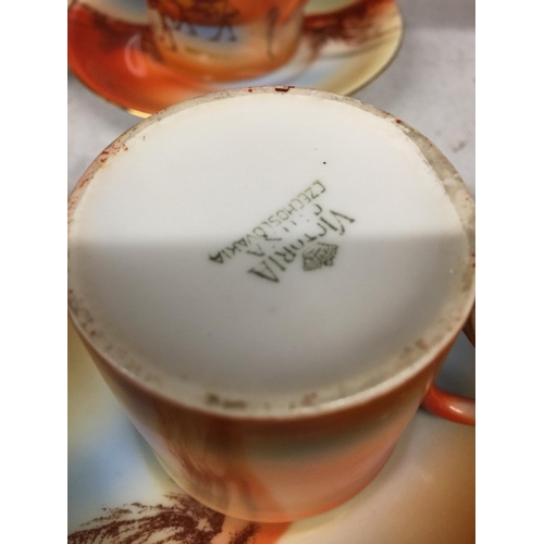 405 - A VICTORIA CHINA, CZECHOSLOVAKIAN COFFEE SET WITH AN IMAGE OF A DESSERT SCENE AND CAMELS, TO INCLUDE... 