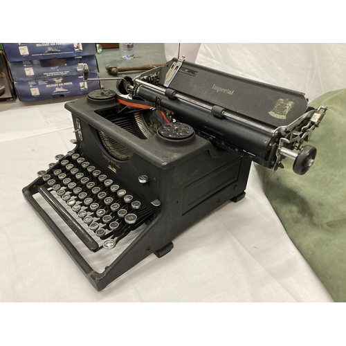 472A - A VINTAGE IMPERIAL TYPEWRITER WITH DUST COVER