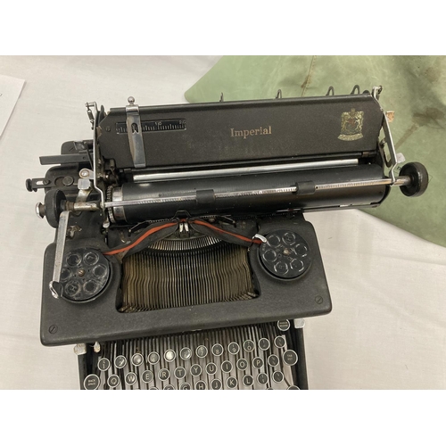 472A - A VINTAGE IMPERIAL TYPEWRITER WITH DUST COVER