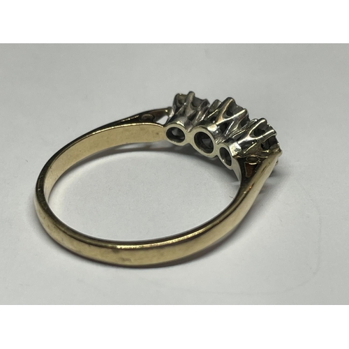 502 - A 9 CARAT GOLD RING WITH THREE IN LINE DIAMONDS SIZE P