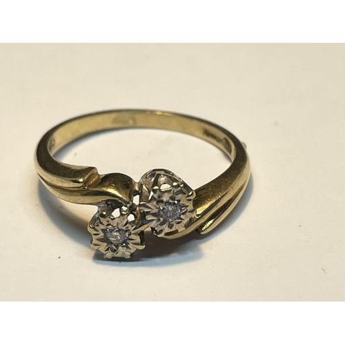 509 - A 9 CARAT GOLD RING WITH TWO DIAMONDS ON A TWIST DESIGN SIZE M