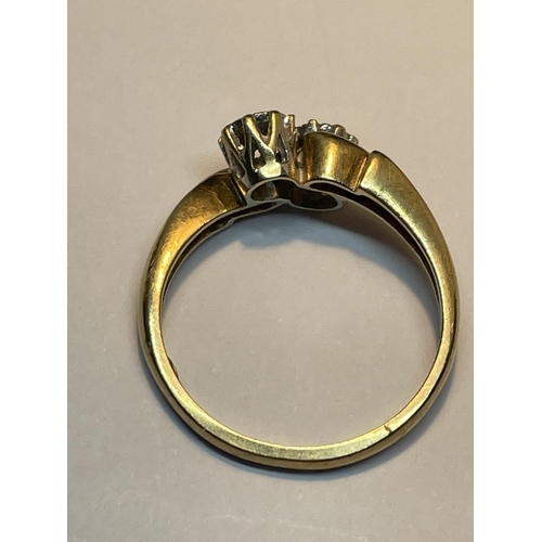 509 - A 9 CARAT GOLD RING WITH TWO DIAMONDS ON A TWIST DESIGN SIZE M