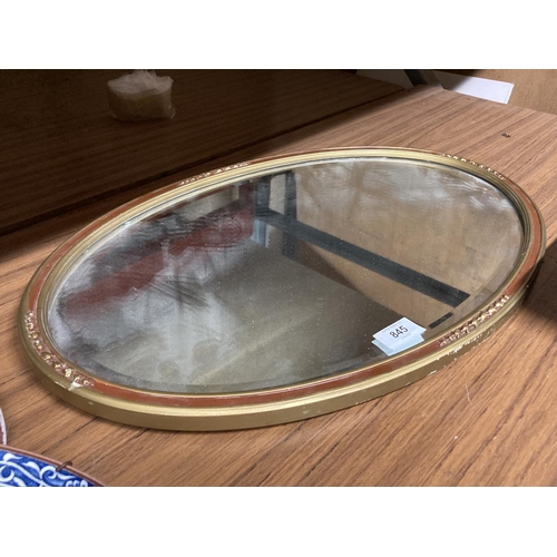 845 - A VINTAGE OVAL MIRROR WITH BEVELLED GLASS 56CM X 36CM