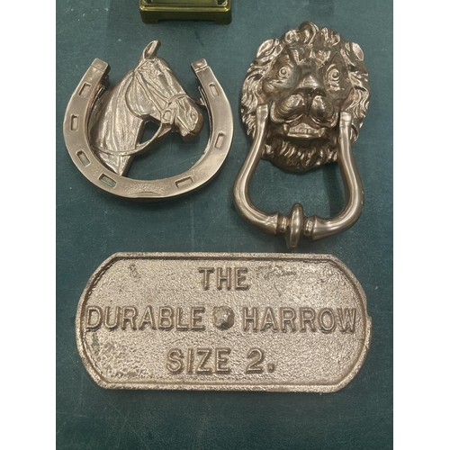 55 - THREE PIECES OF BRONZE COLOURED CAST ITEMS TO INCLUDE A LION AND HORSE DOOR KNOCKER AND A PLAQUE