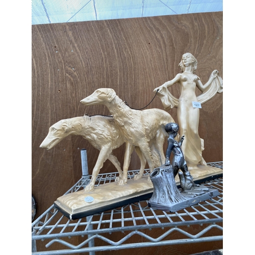 1237 - A RESIN FIGURE OF FEMALE WALKING TWO DOGS AND A SMALL METAL FIGURE OF A YOUNG BOY