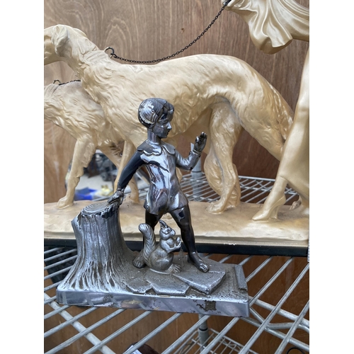 1237 - A RESIN FIGURE OF FEMALE WALKING TWO DOGS AND A SMALL METAL FIGURE OF A YOUNG BOY