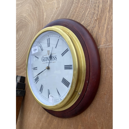 1254 - A WOODEN FRAMED BRASS WALL CLOCK BEARING THE NAME 'GUINNESS'