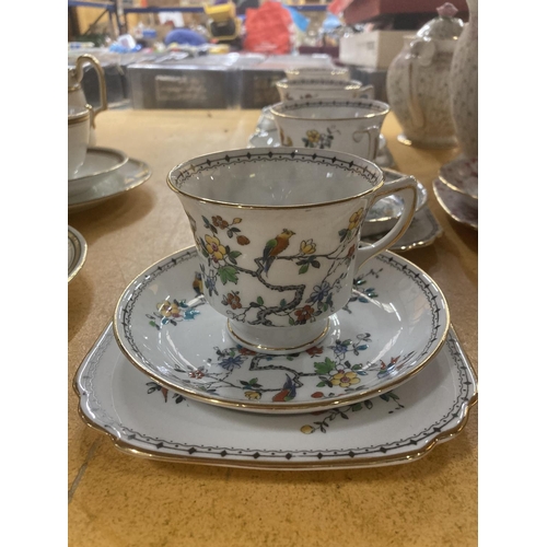 215 - FIVE GROSVENOR CHINA CUPS, SAUCERS AND  FOUR SIDE PLATES WITH A BIRD AND FLORAL DESIGN