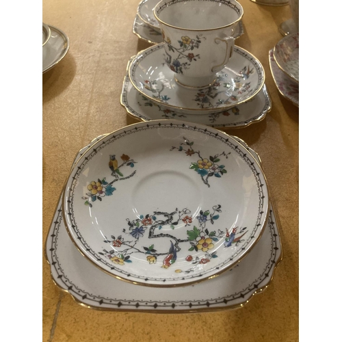 215 - FIVE GROSVENOR CHINA CUPS, SAUCERS AND  FOUR SIDE PLATES WITH A BIRD AND FLORAL DESIGN