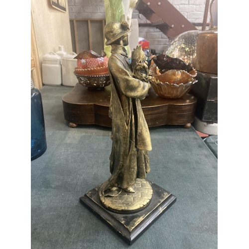 222 - A FIGURINE OF A LADY HOLDING A DOG ON A PLINTH HEIGHT APPROX 33CM