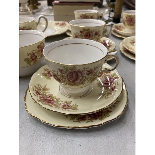 264 - A COLCLOUGH CHINA TEASET IN A PALE YELLOW WITH FLORAL DECORATION TO INCLUDE A CAKE PLATE, CREAM JUG,... 