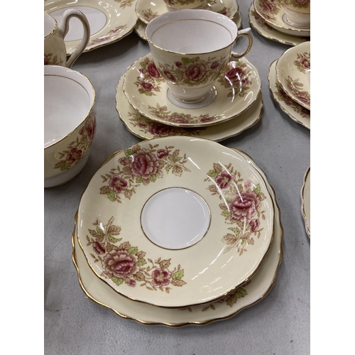 264 - A COLCLOUGH CHINA TEASET IN A PALE YELLOW WITH FLORAL DECORATION TO INCLUDE A CAKE PLATE, CREAM JUG,... 