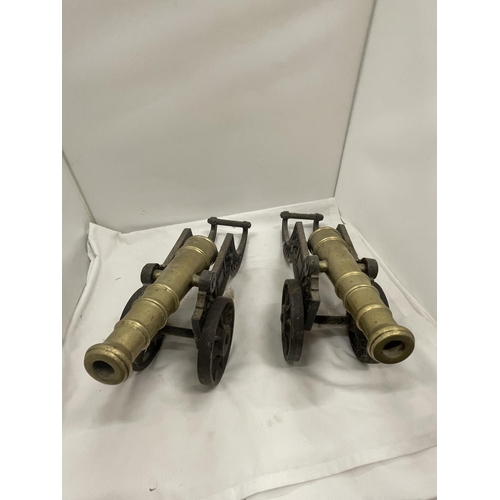 27 - A PAIR OF HEAVY BRASS AND CAST CANNONS