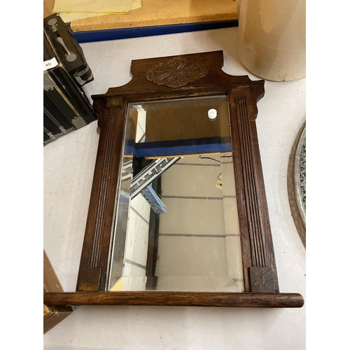 36 - A VICTORIAN OAK FRAMED BEVELLED WALL MIRROR WITH SHELF