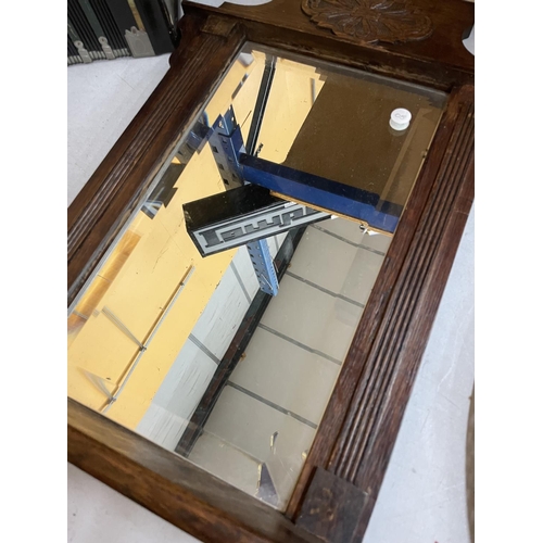 36 - A VICTORIAN OAK FRAMED BEVELLED WALL MIRROR WITH SHELF