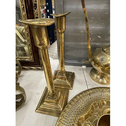 4 - A BRASS AND JEWELLED DALLAH AFTABA POT AND GOBLETS ON TRAY TOGETHER WITH TWO BRASS CANDLESTICKS AND ... 