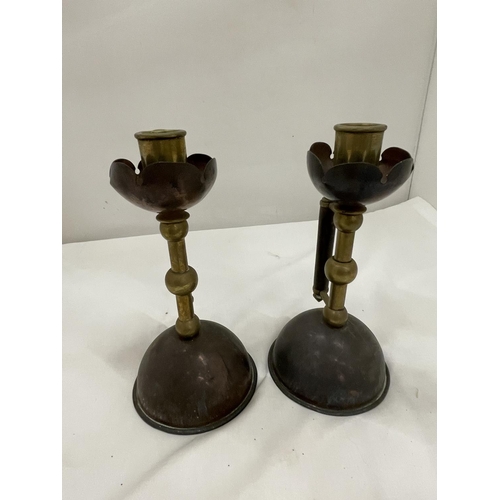 5 - A PAIR OF COPPER AND BRASS CANDLESTICKS IN THE STYLE OF CHRISTOPHER DRESSER