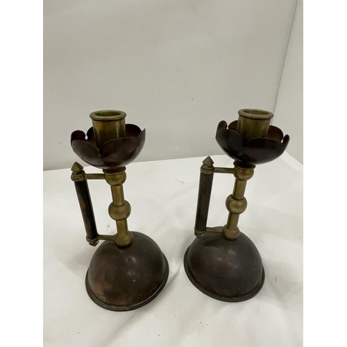 5 - A PAIR OF COPPER AND BRASS CANDLESTICKS IN THE STYLE OF CHRISTOPHER DRESSER