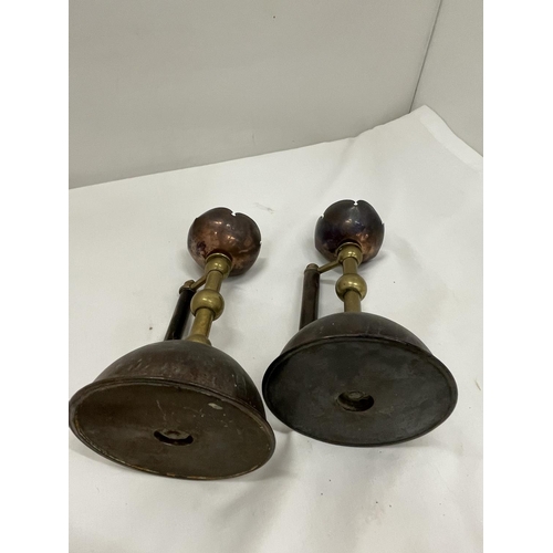 5 - A PAIR OF COPPER AND BRASS CANDLESTICKS IN THE STYLE OF CHRISTOPHER DRESSER