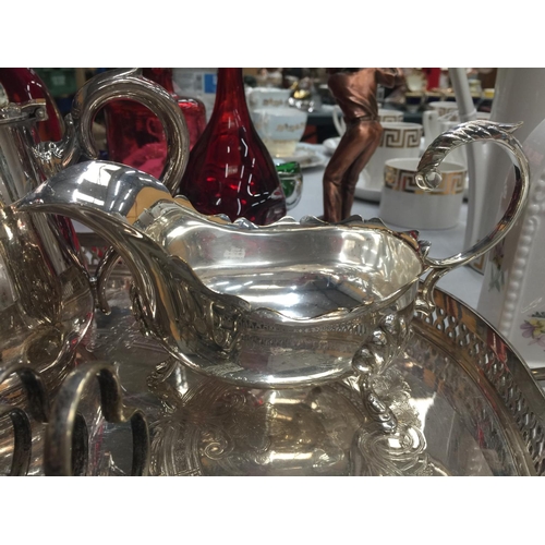 197 - A QUANTITY OF SILVER PLATED ITEMS TO INCLUDE TWO TRAYS, A TEAPOT, SAUCE BOAT AND TOAST RACK