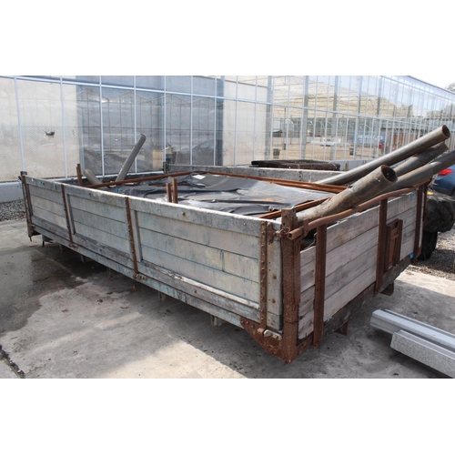 239 - A WOODEN TRAILER BODY WITH AN ASSORTMENT OF PLASTIC PIPES, TYRES AND SIGNS +VAT