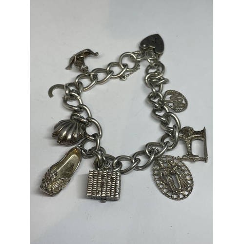 622 - A SILVER CHARM BRACELET WITH EIGHT CHARMS