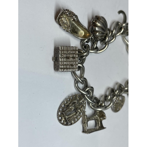 622 - A SILVER CHARM BRACELET WITH EIGHT CHARMS