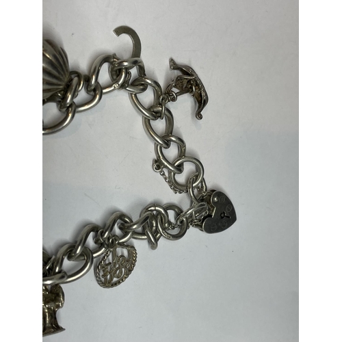 622 - A SILVER CHARM BRACELET WITH EIGHT CHARMS