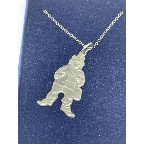 635 - A SILVER NECKLACE WITH A LEPRECHAUN PENDANT IN A PRESENTATION BOX