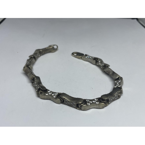 639 - A SILVER BRACELET WITH STONES