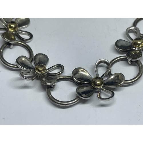 646 - A SILVER AND GOLD DAISY BRACELET