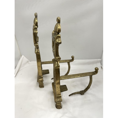 26 - A PAIR OF BRASS FIRE DOGS