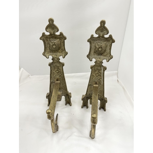 26 - A PAIR OF BRASS FIRE DOGS