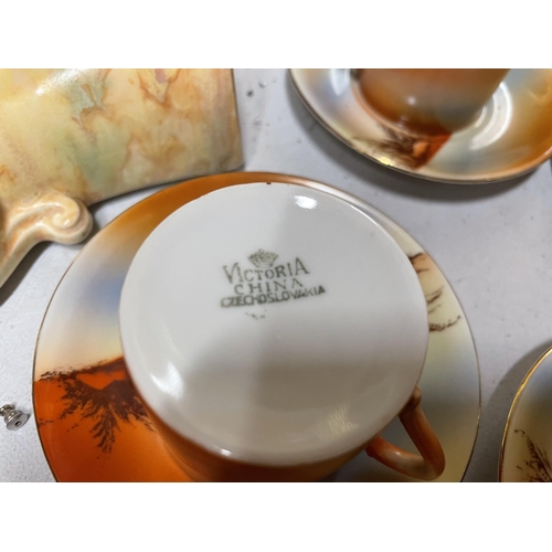 316 - A VICTORIA CHINA, CZECHOSLOVAKIAN COFFEE SET WITH AN IMAGE OF A DESSERT SCENE AND CAMELS, TO INCLUDE... 