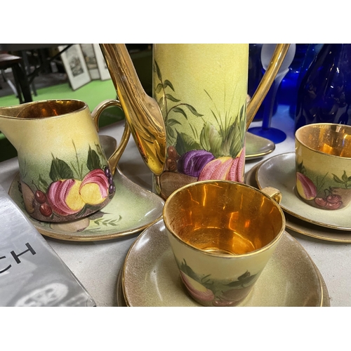 324 - A HAND PAINTED COFFEE SET WITH FRUIT DESIGN AND GILT INNER TO INCLUDE A COFFEE POT, CREAM JUG, SUGAR... 