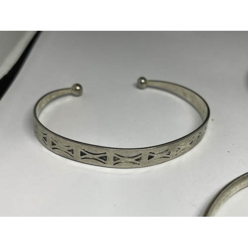 527 - THREE SILVER BANGLES