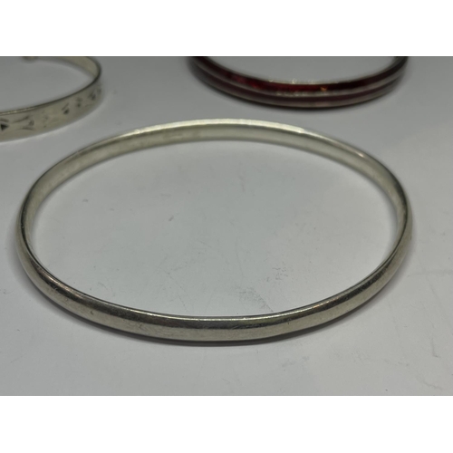 527 - THREE SILVER BANGLES