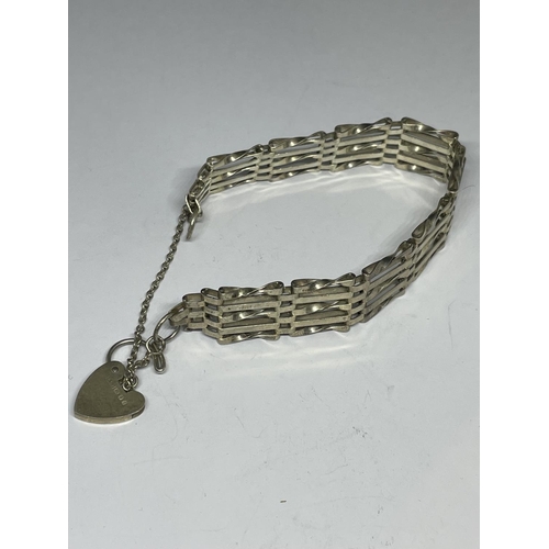 602 - A MARKED SILVER FIVE BAR GATE BRACELET