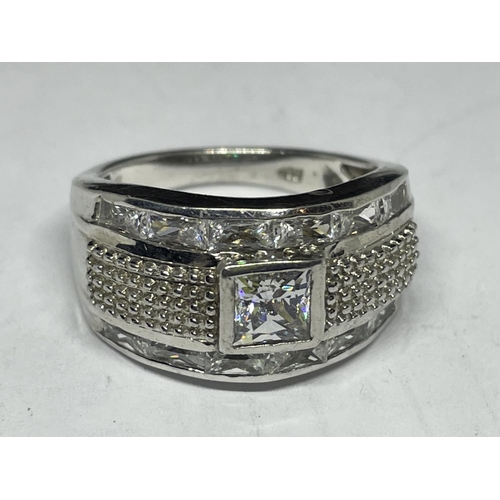 610 - A SILVER RING WITH A LARGE CENTRE CLEAR STONE AND SURROUNDING STONES SIZE Q/R IN A PRESENTATION BOX