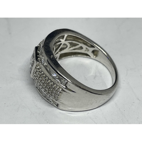 610 - A SILVER RING WITH A LARGE CENTRE CLEAR STONE AND SURROUNDING STONES SIZE Q/R IN A PRESENTATION BOX