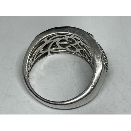 610 - A SILVER RING WITH A LARGE CENTRE CLEAR STONE AND SURROUNDING STONES SIZE Q/R IN A PRESENTATION BOX