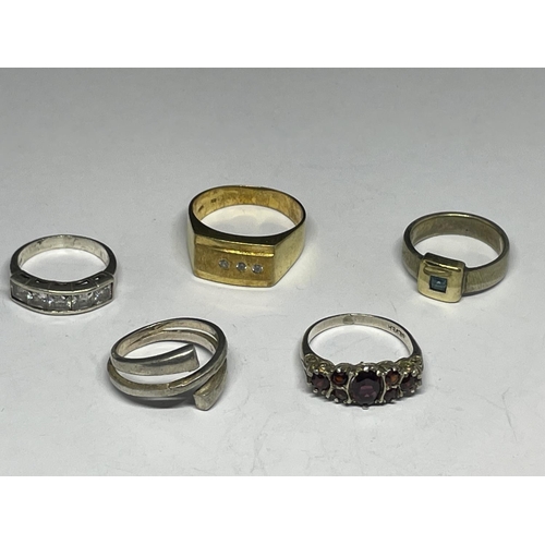 611 - FIVE SILVER AND SILVER GILT RINGS