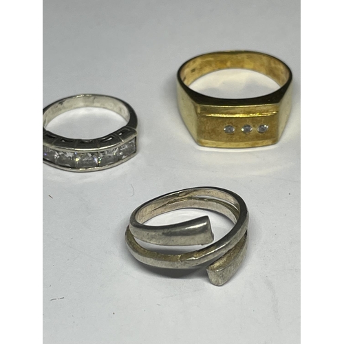 611 - FIVE SILVER AND SILVER GILT RINGS