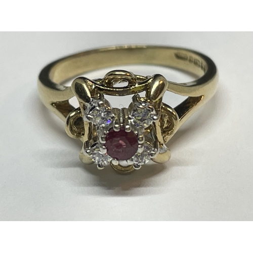 657 - A 9 CARAT GOLD RING WITH CENTRE RUBY SURROUNDED BY CUBIC ZIRCONIAS SIZE K