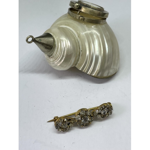 679 - A SHELL PILL BOX AND A YELLOW METAL BROOCH WITH CLEAR STONES