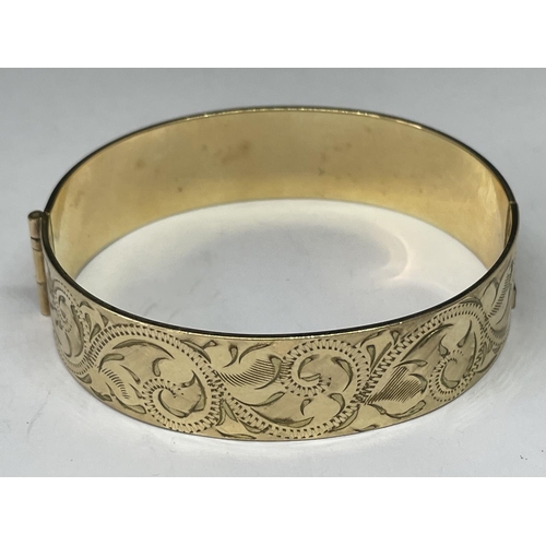 694 - A 9 CARAT GOLD PLATED BANGLE