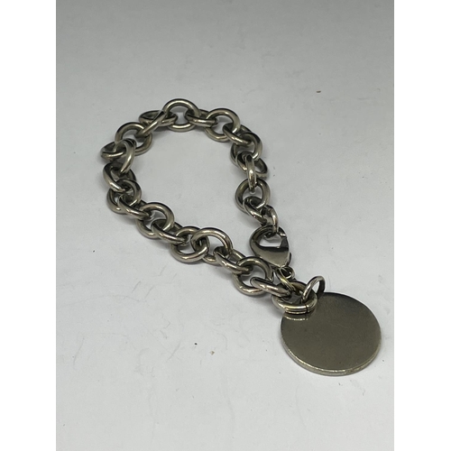 698 - A SILVER BRACELET WITH A FOB