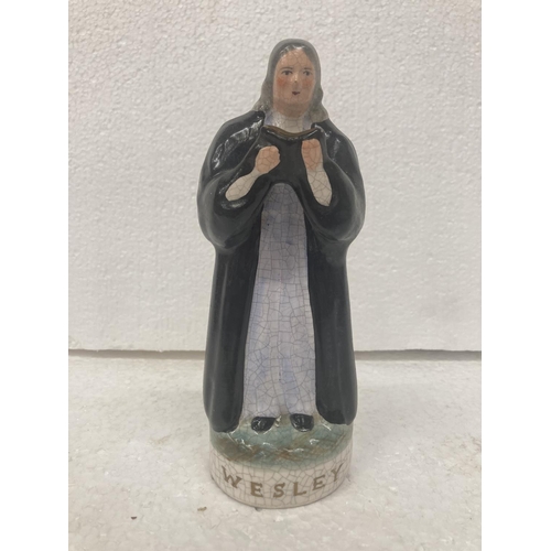 711 - A STAFFORDSHIRE POTTERY FIGURE OF JOHN WESLEY- 17.5 CM